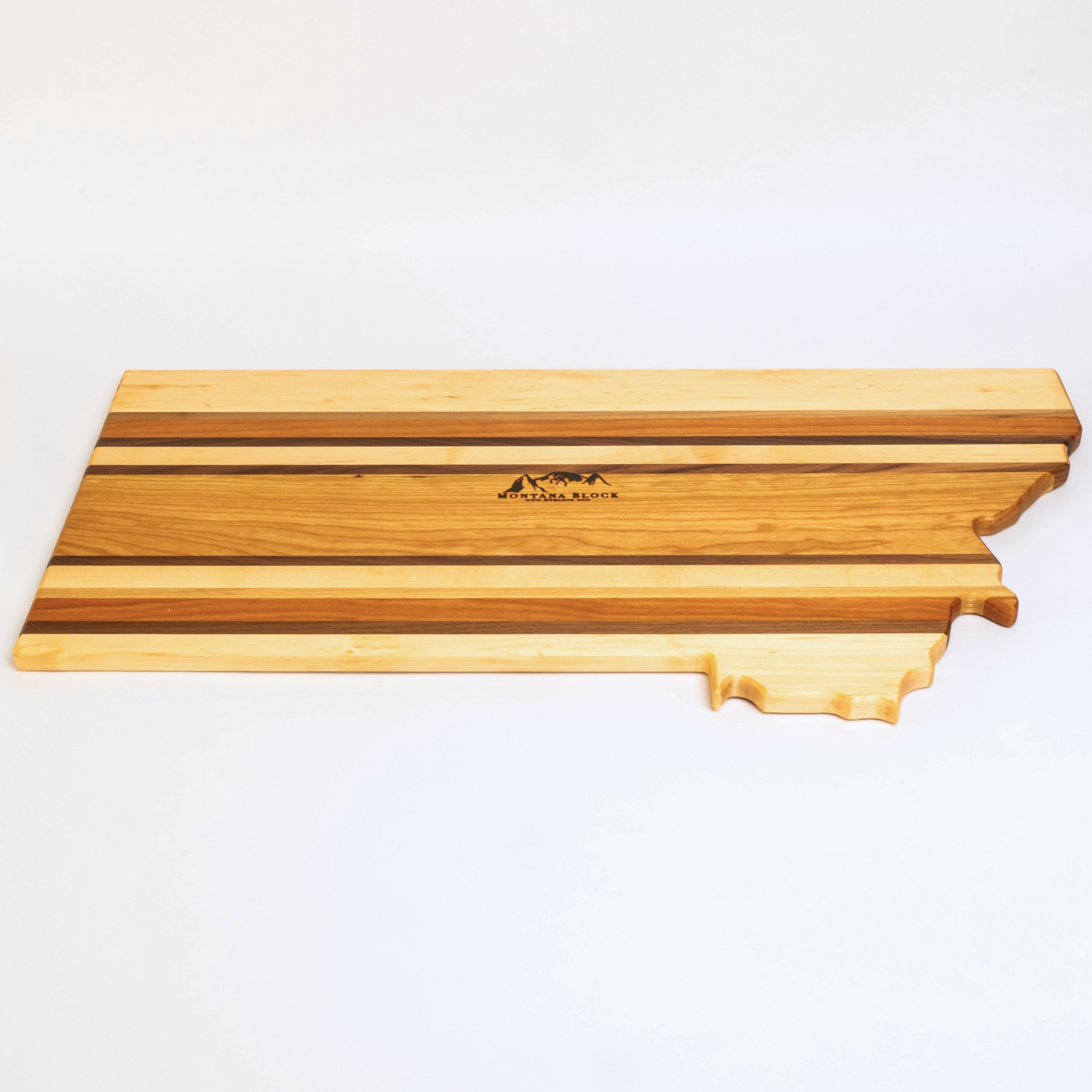 Wooden cutting board shaped like the state of Tennessee on a white background