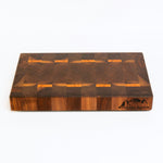 Wooden cutting board with a checkered pattern on a white background