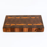 Wooden cutting board with a checkered pattern on a white background