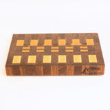 Wooden cutting board with a checkered pattern on a white background