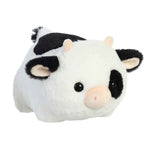 Plush toy cow with black and white pattern on a white background
