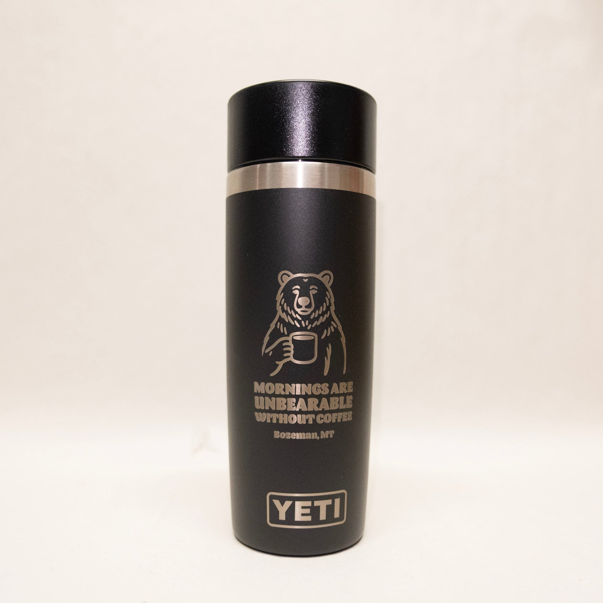 Black YETI mug with bear graphic and text on a white background