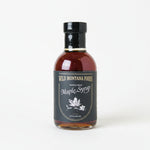 Bottle of Wild Montana Foods Maple Syrup on a white surface
