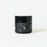 Black jar of wild montana foods vanilla paste with a label on a white surface