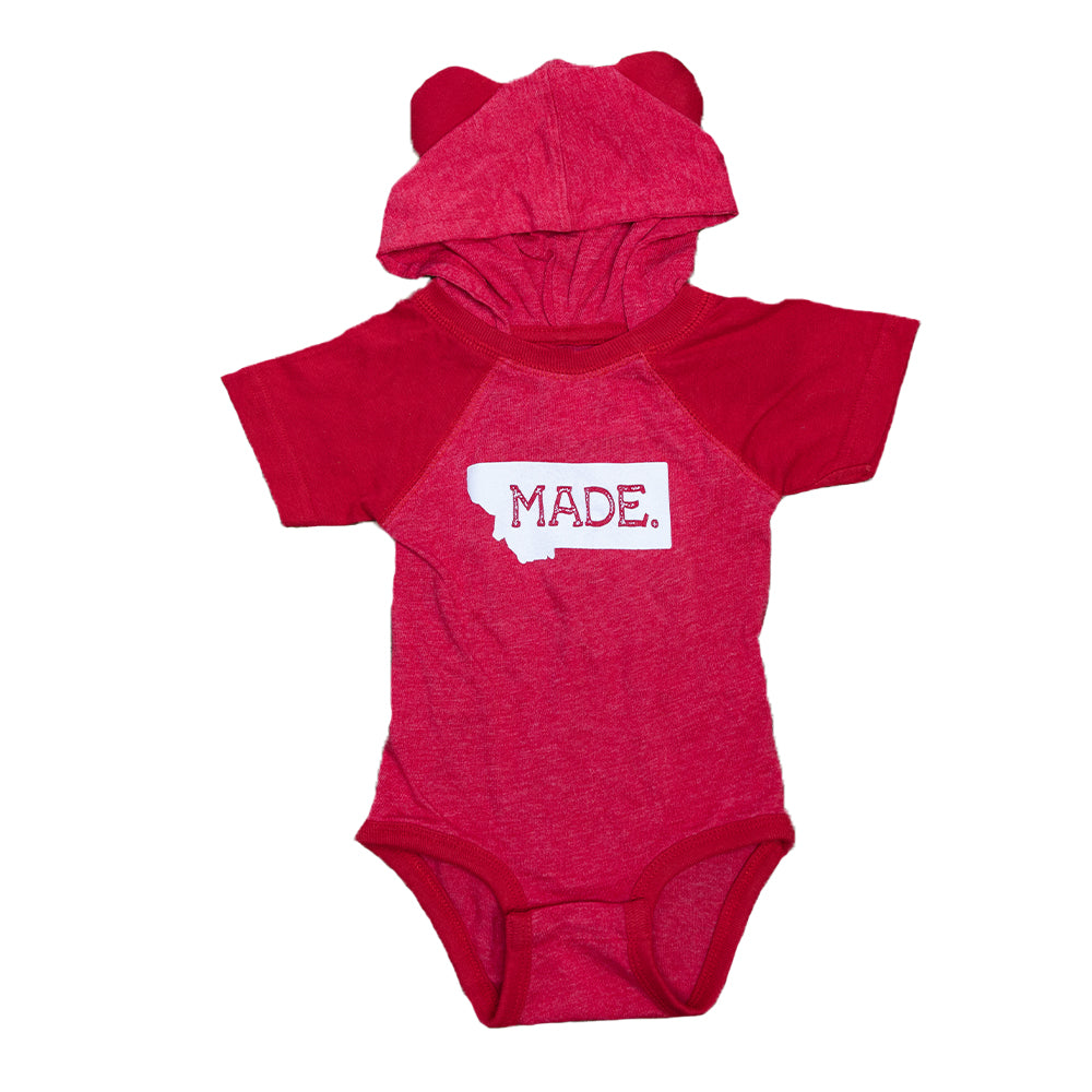 The perfect way to commemorate your little one being born in the great State of Montana is with this Vintage Red Montana Made Onesie by Cody Sarrazin.
