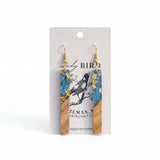 Wooden and blue earrings on a branded card with a white background