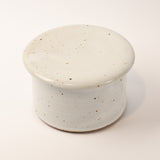 Speckled ceramic container on a white background