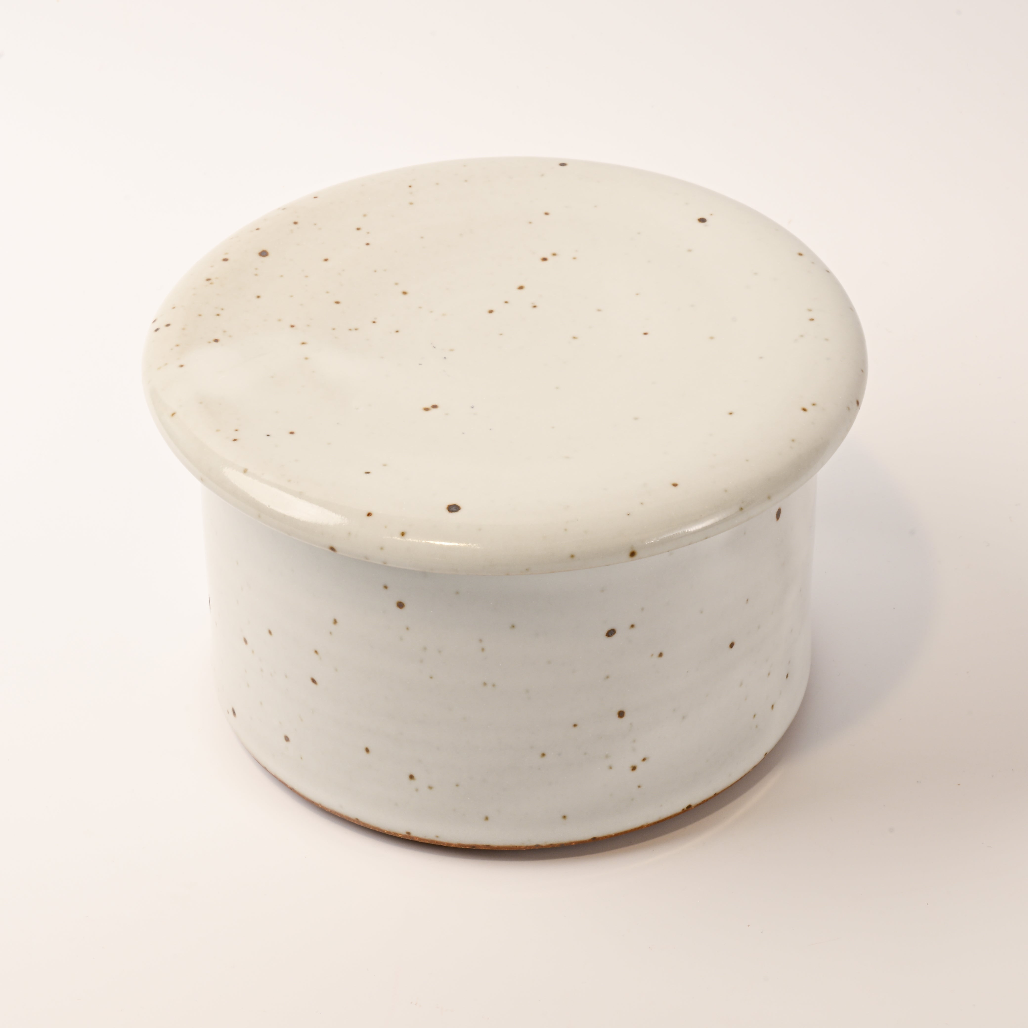 Speckled ceramic container on a white background