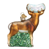 Decorative deer ornament with gold antlers and green base on a white background