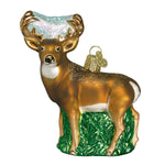 Decorative deer ornament with gold antlers and green base on a white background
