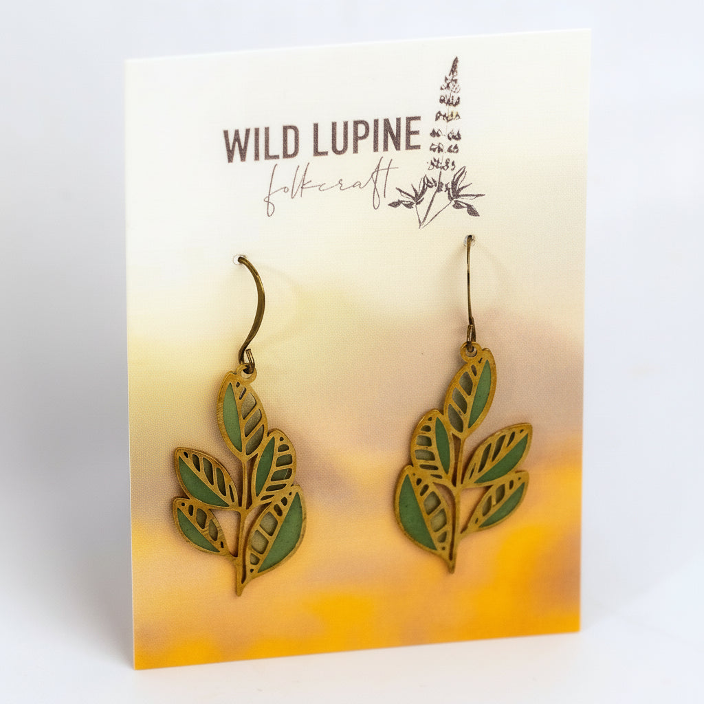Pair of leaf-shaped earrings on a Wild Lupine Felicraft branded card.