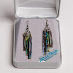 A set of abalone shell earrings in the shape of wind chimes set in a grey clamshell box.