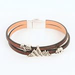Bracelet with mountain-shaped charms on a white background