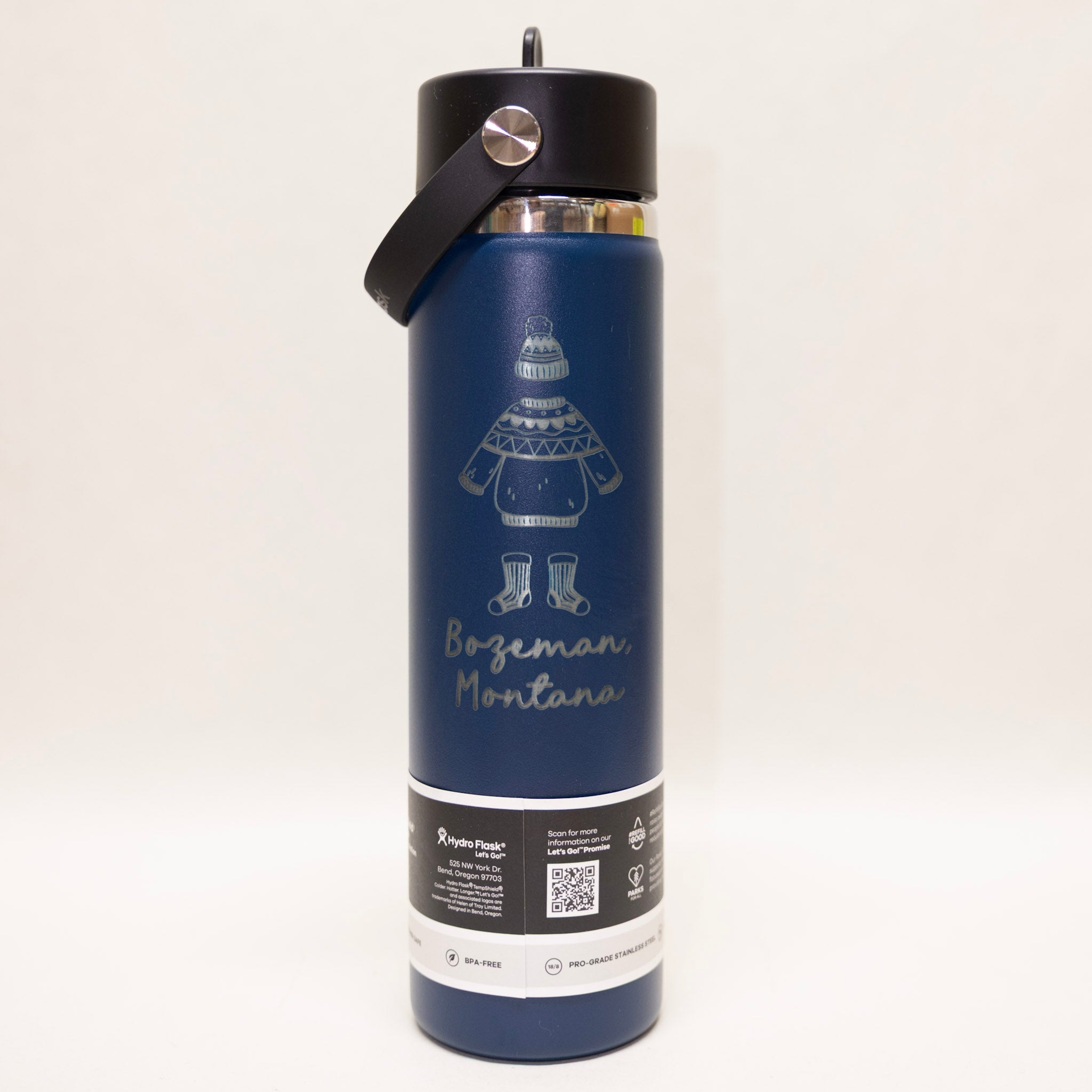 Blue insulated bottle with black lid on a white background