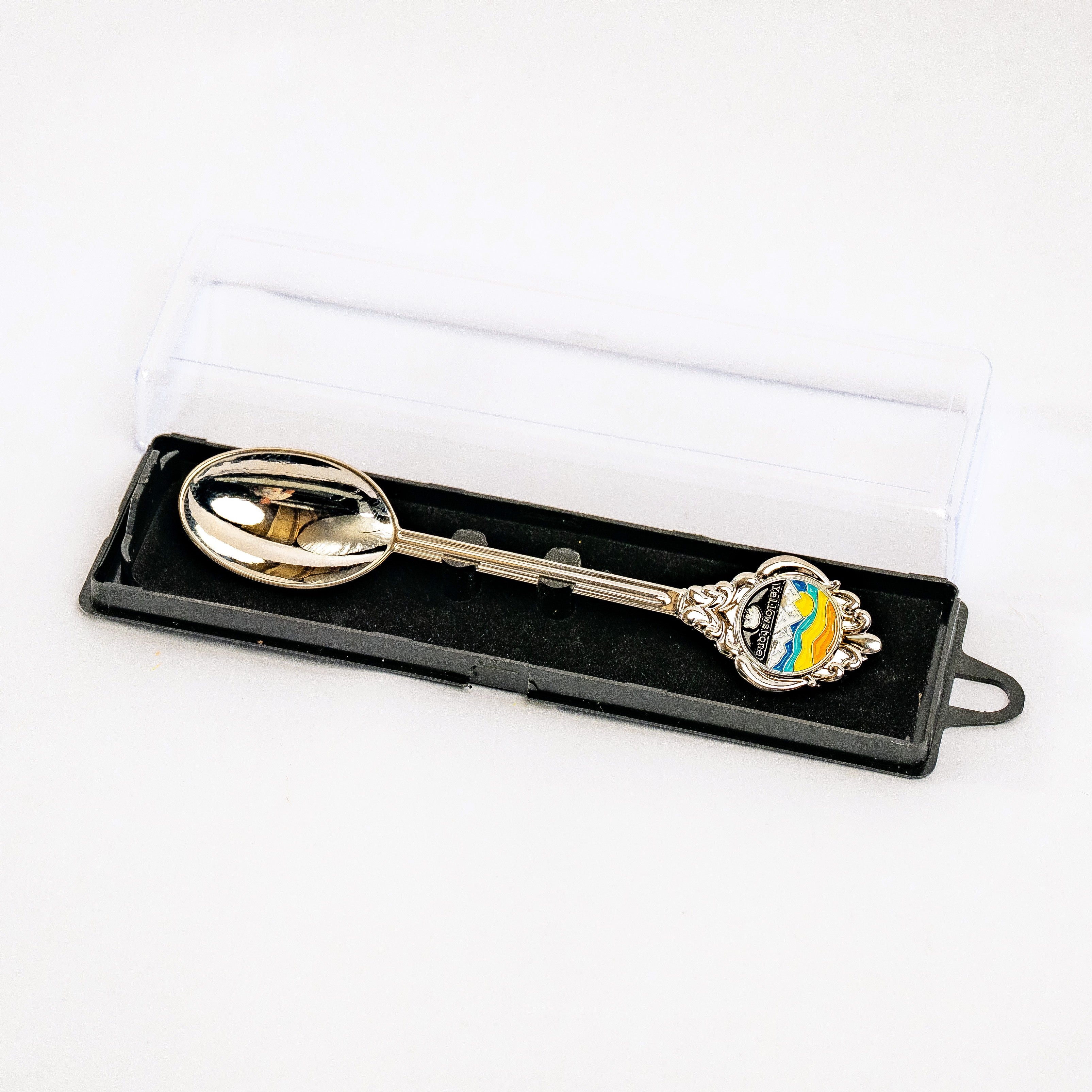 Decorative spoon in a black box on a white background