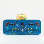 Decorative tray with nature-themed design featuring flowers, insects, and a skull, holding a can of Latacoa wine.
