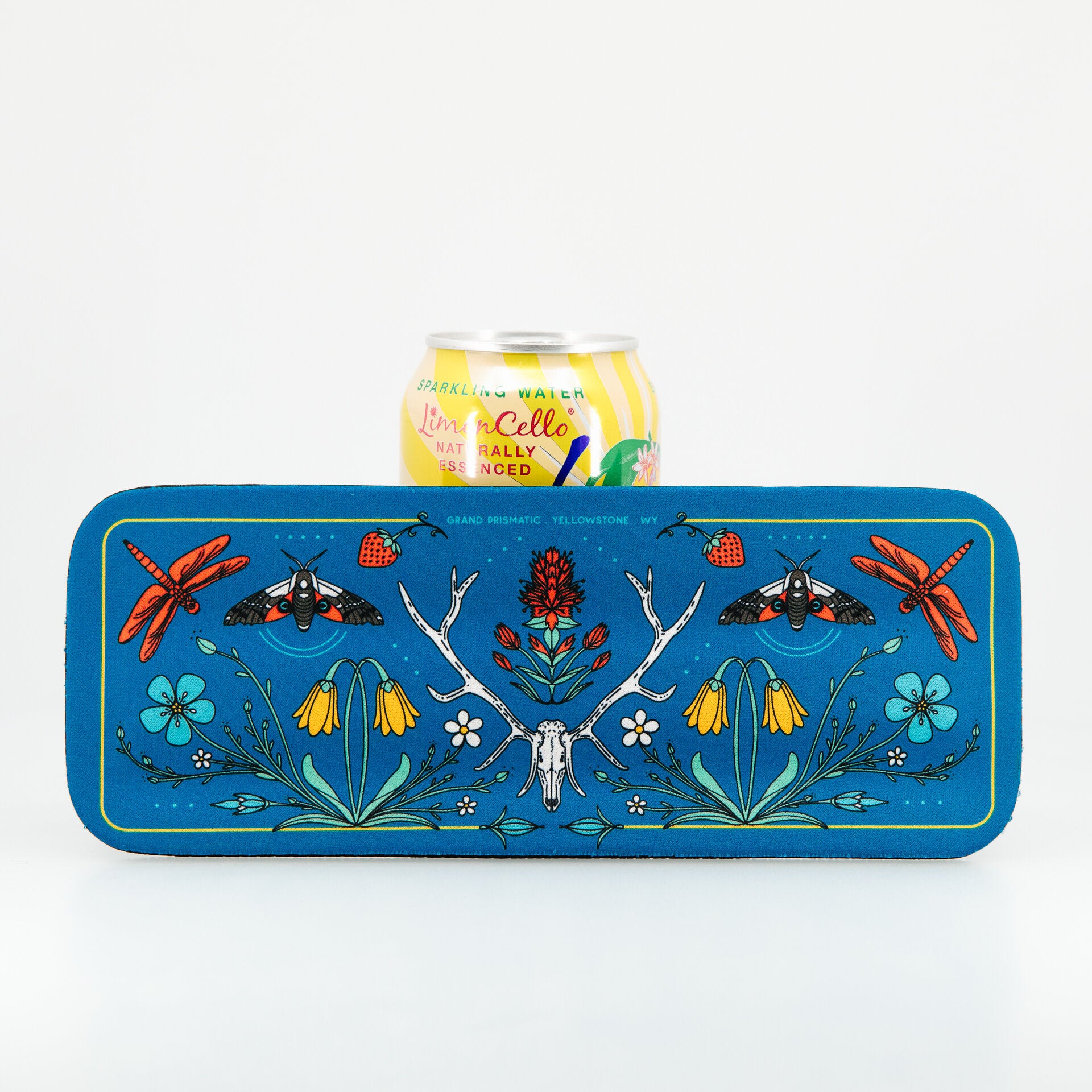 Decorative tray with nature-themed design featuring flowers, insects, and a skull, holding a can of Latacoa wine.