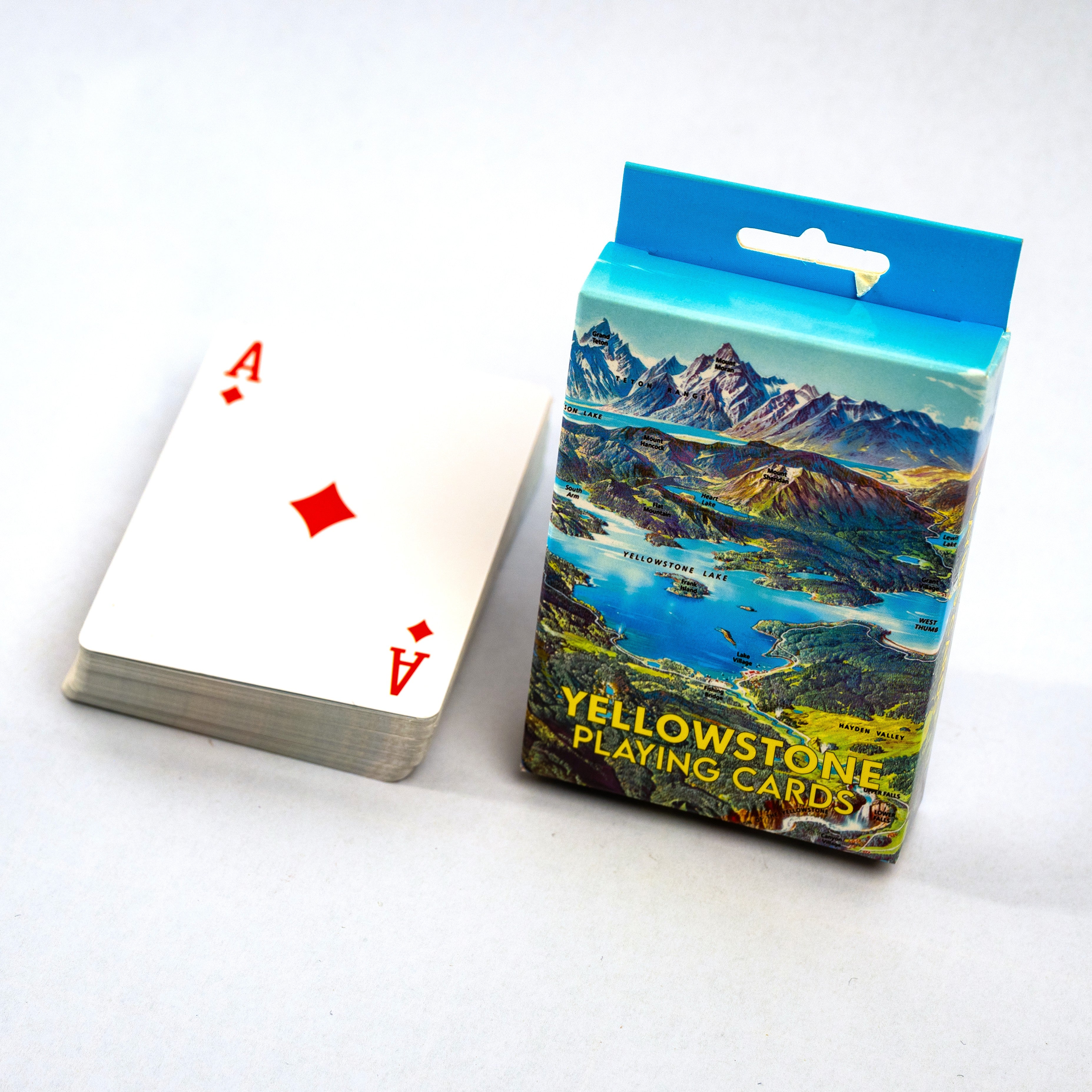 Playing cards with an Ace of Diamonds and a box labeled 'Yellowstone Playing Cards' on a white background.