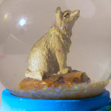 Snow globe with wolf design and 'Yellowstone National Park' base on a white background