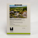 A printed booklet or guidebook titled Yellowstone Forever, shown standing against a plain light background. The cover features a landscape photo of a national park, descriptive text, a list of highlights, and a Yellowstone Forever logo at the bottom.