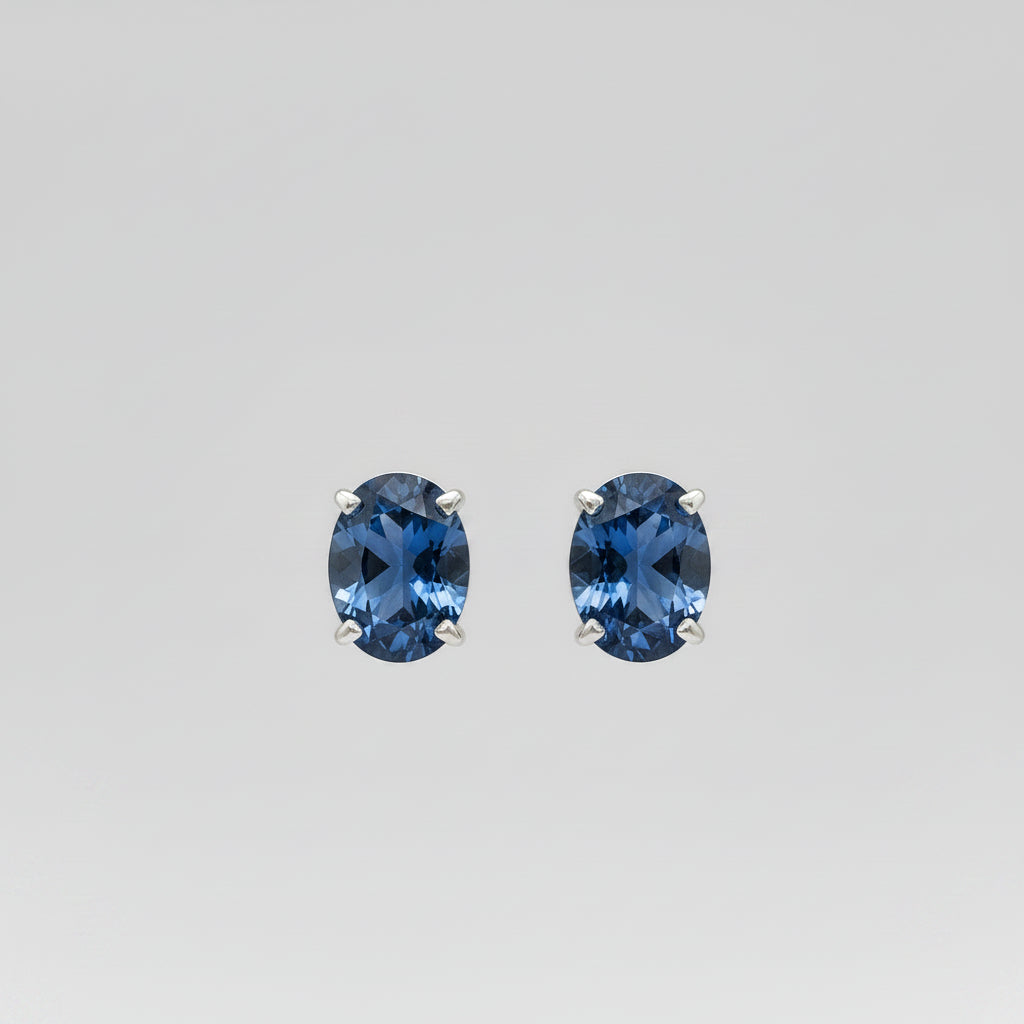 Pair of blue Yogo sapphire earrings on a white background