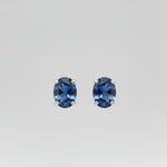 Pair of blue Yogo sapphire earrings on a white background