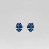 Pair of blue Yogo sapphire earrings on a white background