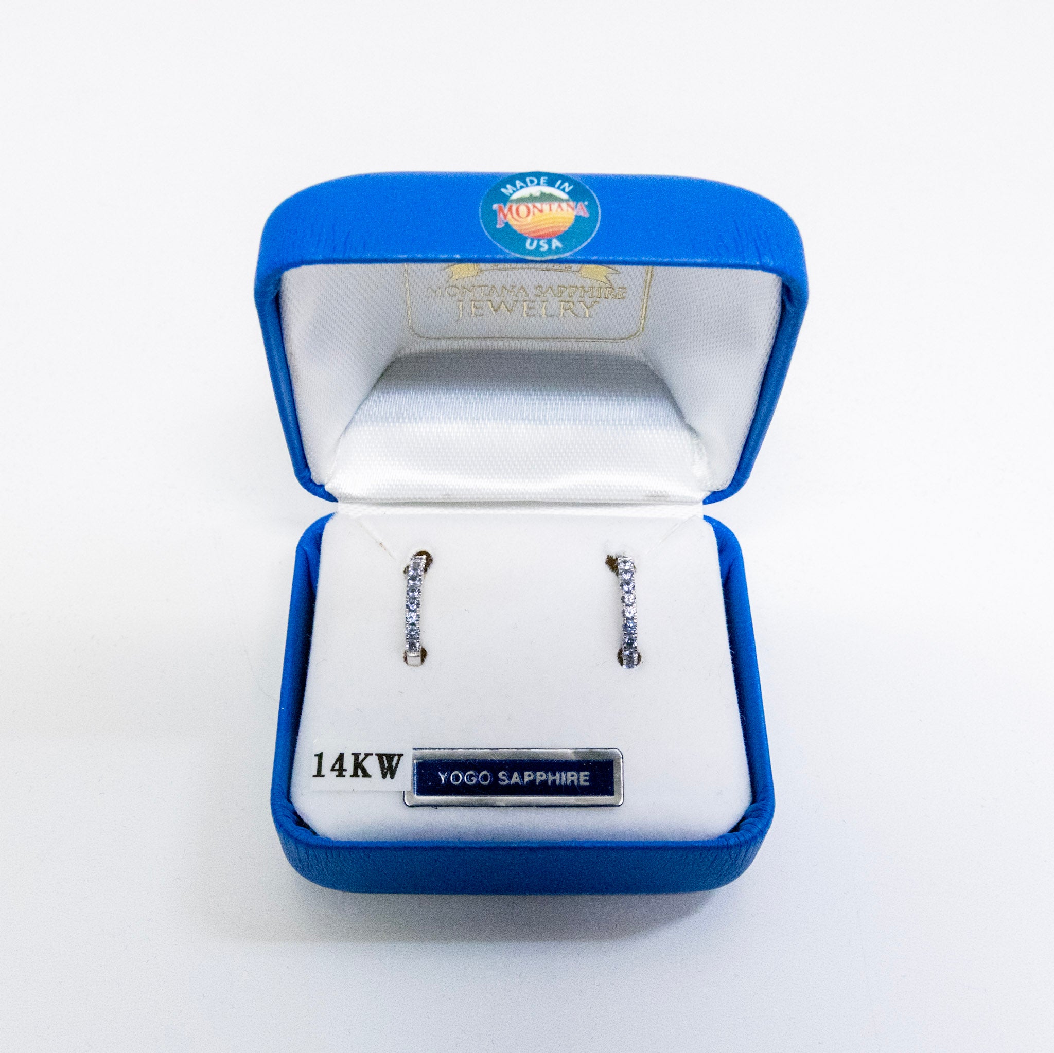 Jewelry box with 14KW Yogo Sapphire earrings on a white background