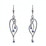 Sterling Silver earrings with Yogo sapphire blue gemstones on a white card