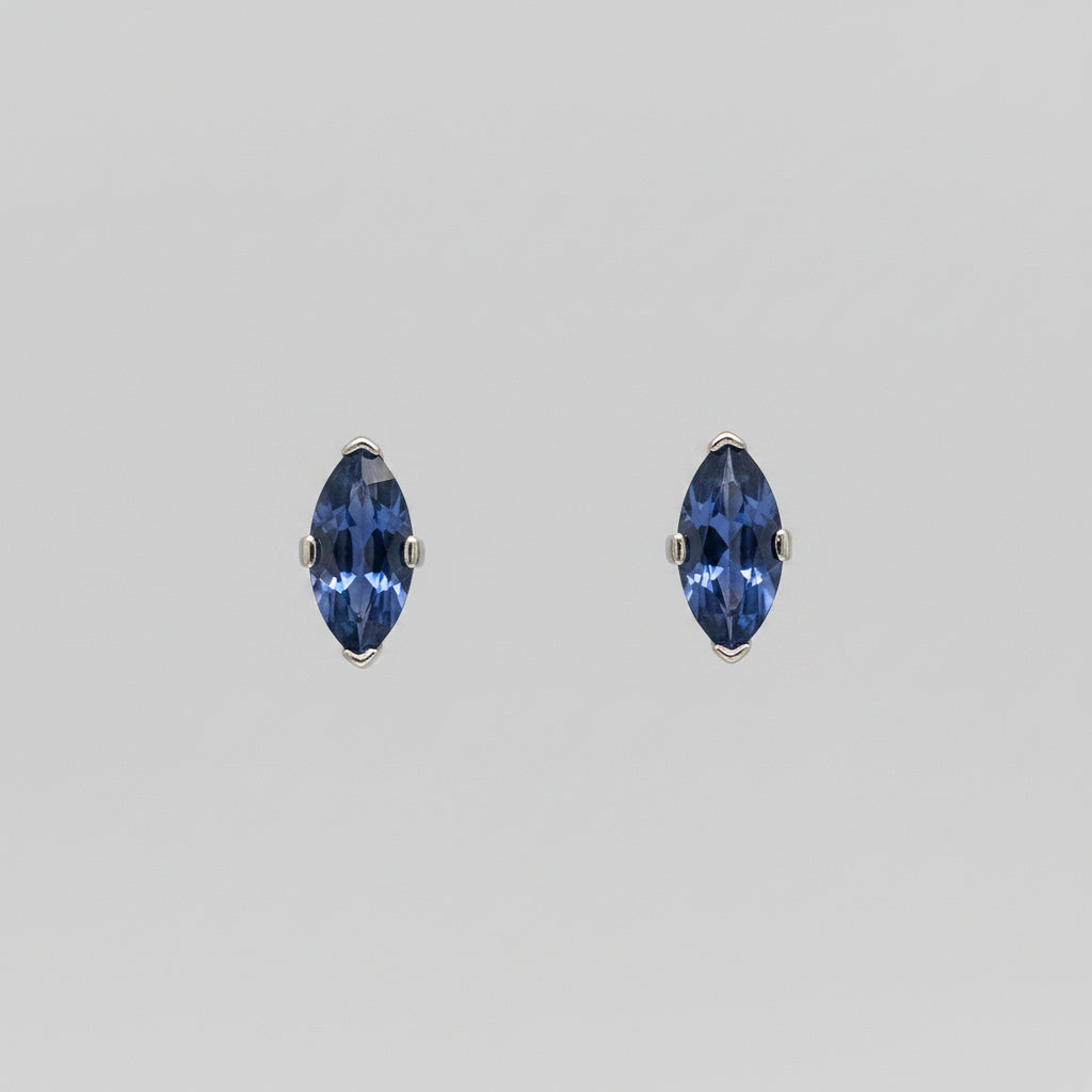 Pair of Yogo sapphire earrings on a white background