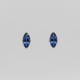 Pair of Yogo sapphire earrings on a white background