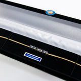 Gold bracelet blue sapphire stones in a black display box