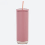 Pink tumbler with a straw on a white background