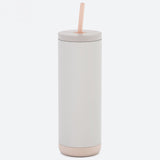 White tumbler with a beige base and straw on a white background