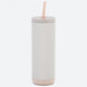 White tumbler with a beige base and straw on a white background