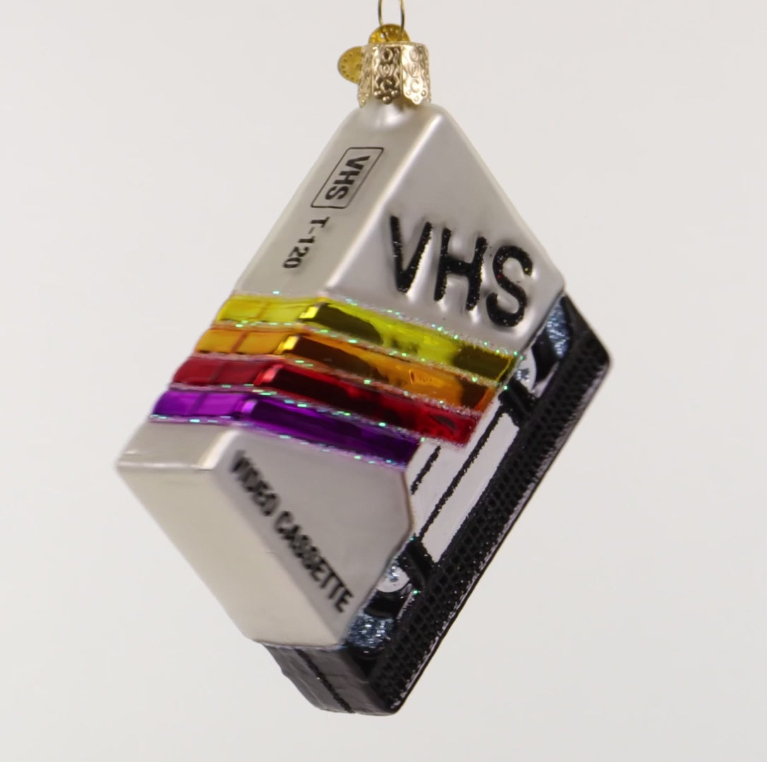 VHS video cassette ornament with colorful design on a white 