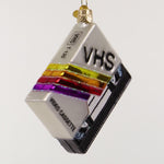 VHS video cassette ornament with colorful design on a white 