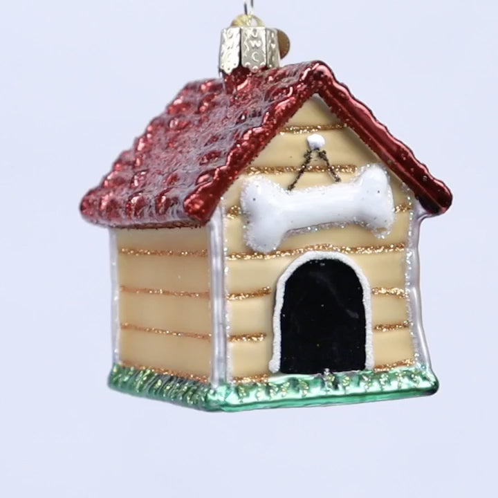 Doghouse ornament with red roof and white bone on a white background