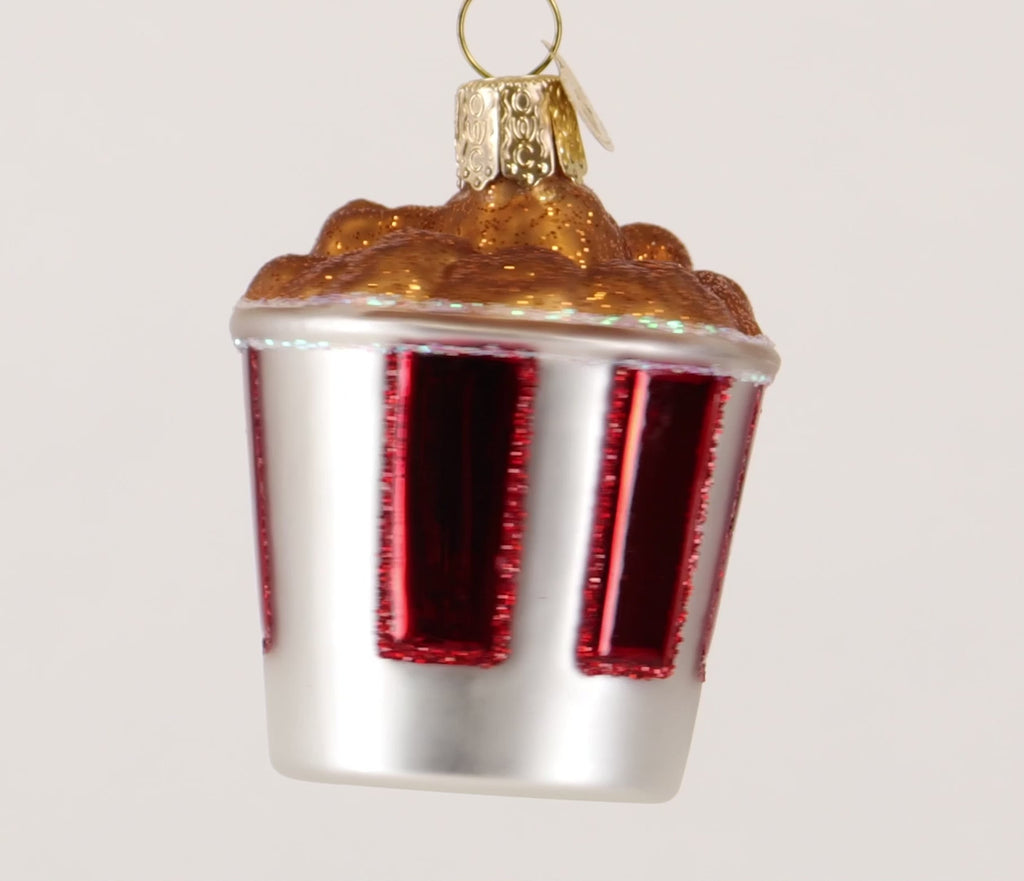 Glass ornament resembling a Kentucky Fried Chicken cup with fried chicken on top.