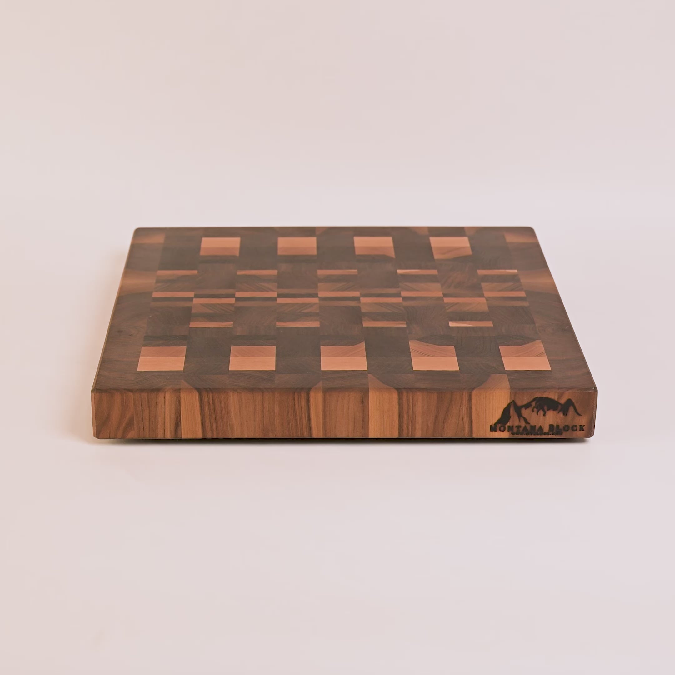 Wooden cutting board with a checkered pattern on a white background