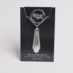 Silver pendant necklace on a black card with branding and contact information.