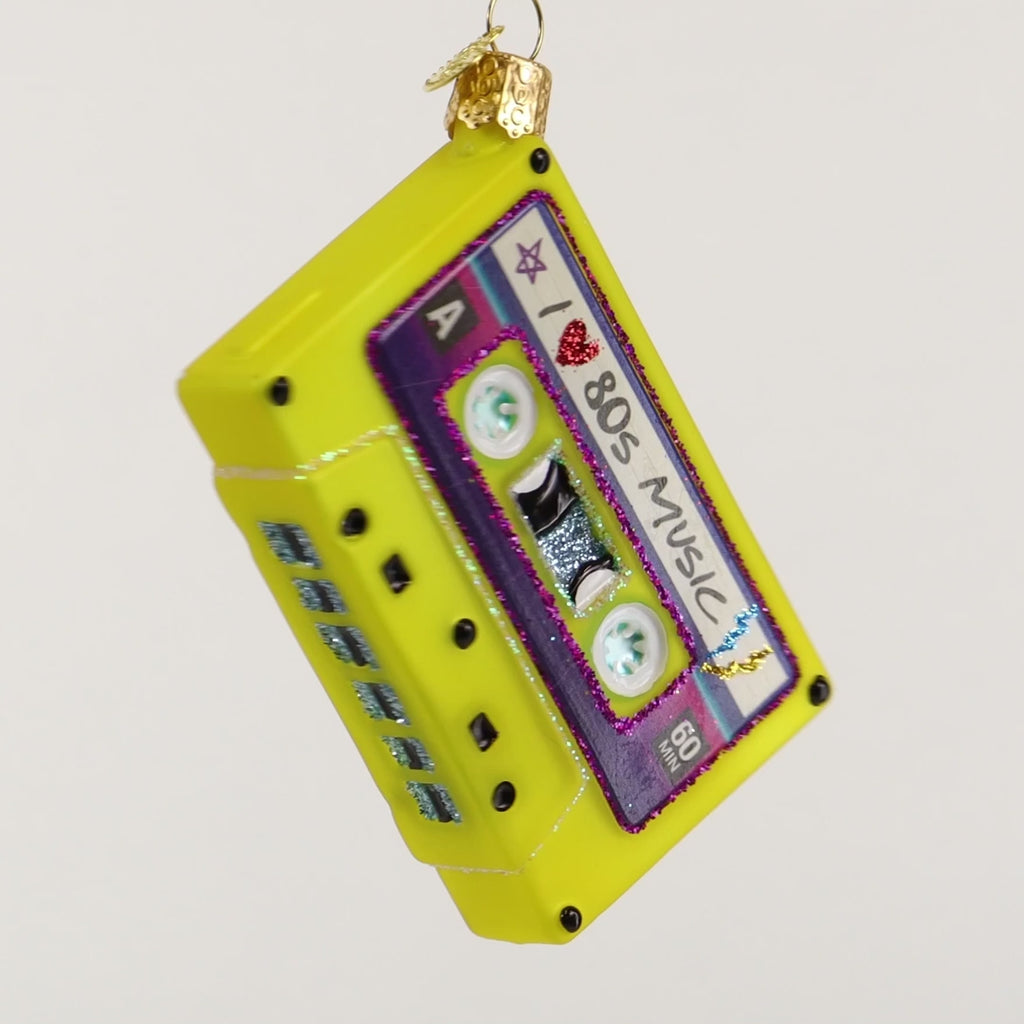 Decorative ornament shaped like a cassette tape with 'I love 80s music' text on a white background
