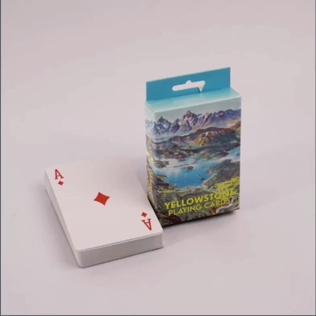 Playing cards with an Ace of Diamonds and a box labeled 'Yellowstone Playing Cards' on a white background.