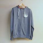 Blue hoodie with a logo on a hanger against a white background