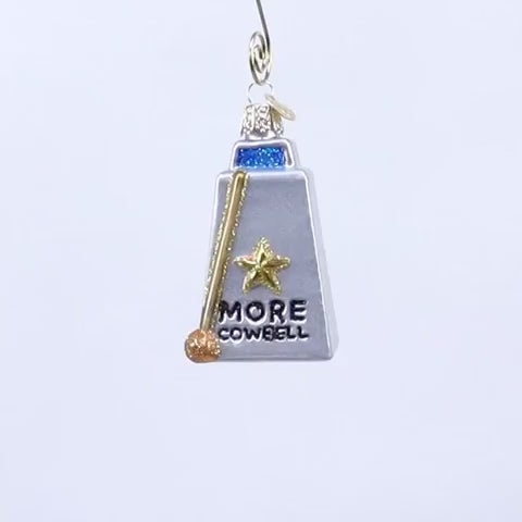 Decorative glass cowbell with a star and 'More Cowbell' text on a white background
