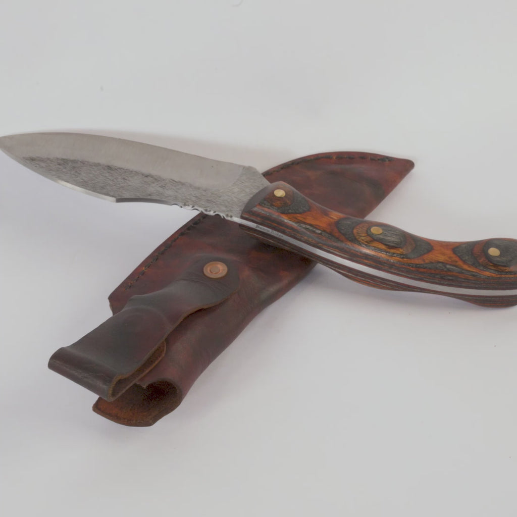 Knife with wooden handle and leather sheath on a white background