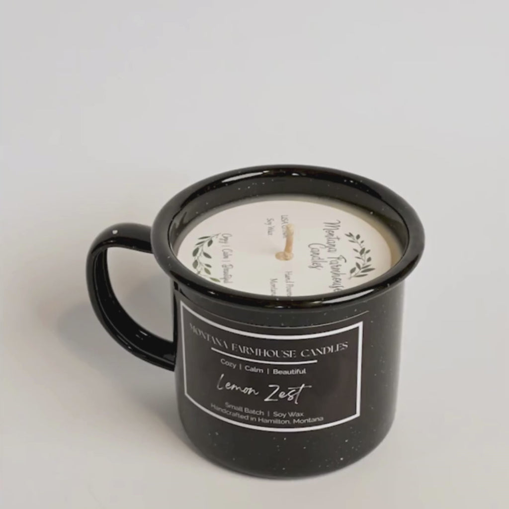 Black mug candle with 'Montana Farmhouse Candles' label on a white background