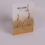 Earrings with mountain design on a Wild Lupine Folkcraft branded card.