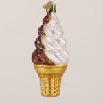 Decorative glass ice cream cone ornament with brown and white swirls on a white background