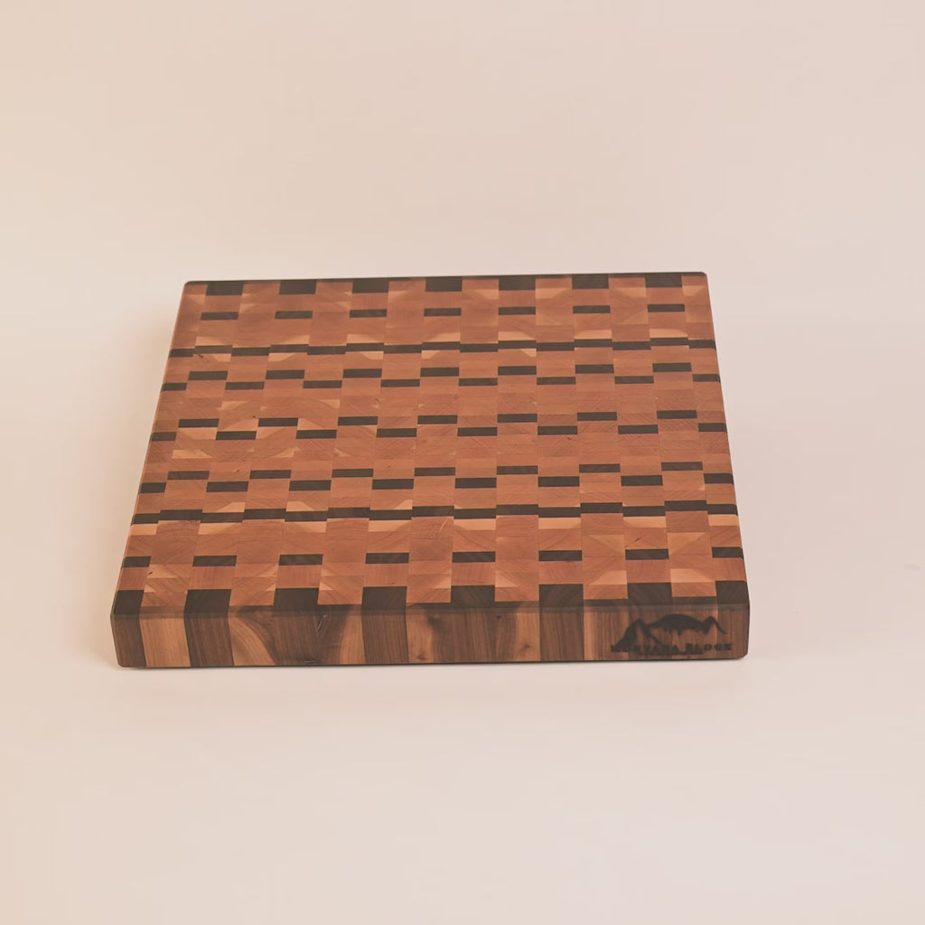 Wooden cutting board with a checkered pattern on a white background